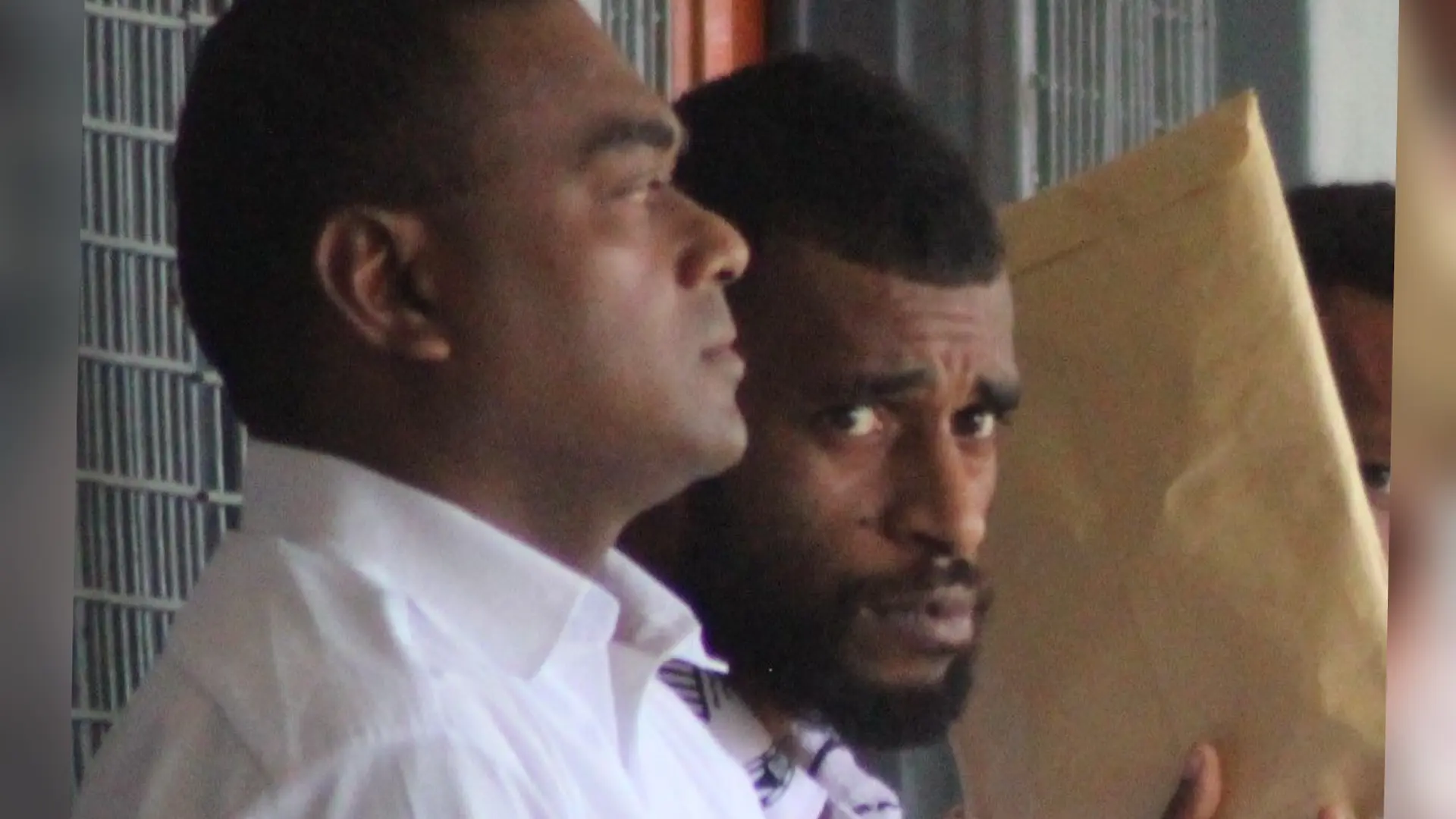 Sekove Asama (holding an envelope)