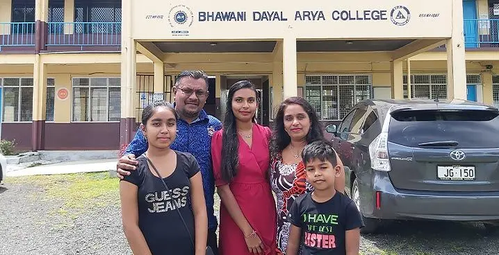 Anushika Singh (middle) with her father Atish (left), mother Shareeen (right), and her two younger siblings Akansha and Avik outside Bhawani Dayal Arya College in Nakasi on January 23, 2023 Photo: Ashna Kumar