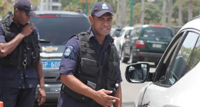 A Police officer assist a motorist. Photo: Ronald Kumar