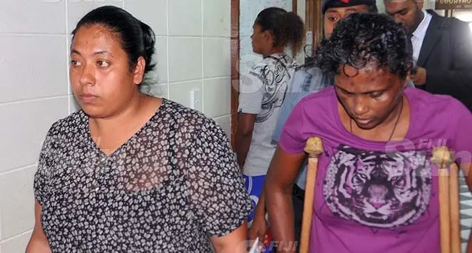 Geeta Devi (left) and Sundar Kaur (right on crutches) are escorted to the High Court in Lautoka by Police officers. Photo: Salote Qalubau