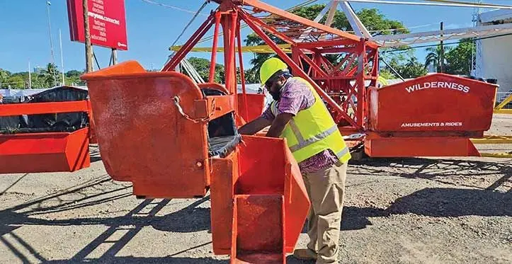 A National Occupational Health and Safety Service officer inspects a Ferris wheel at the Fiji Showcase 2023.