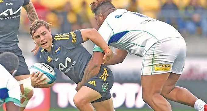 Swire Shipping Fijian Drua number eight Te Ahiwaru Cirikidaveta tackles Hurricane’s Aidan Morgan during their Super Rugby match in Wellington on May 8, 2022. The Fijian Drua will take on the Moana Pasifika this Saturday at the 4:35pm at CommBank Stadium, Sydney.
