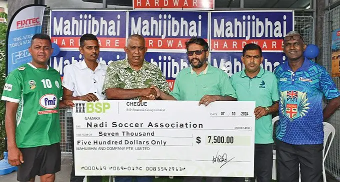 Nadi Football Association president Mohin Rafiq (third from left) receives the cheque from Sudish Patel on October 11, 2024. Photo: Waisea Nasokia