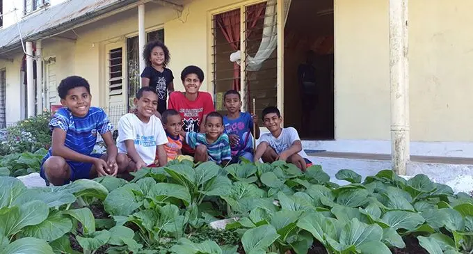 Seargant Sunia Maniyala’s family, outside the Raiwaqa Police Barracks with their vegetable garden. Photo: Police Media Unit