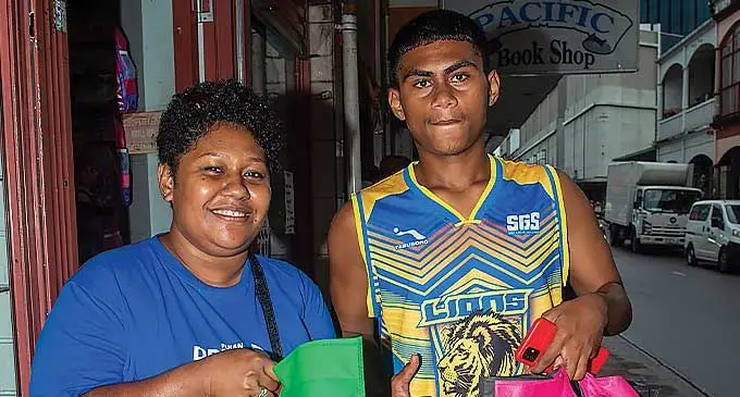 Siblings Amelia Volavola (left) and Alex Suliano aftert their back-to-school shopping in Suva on January 24, 2024. Photo: Leon Lord