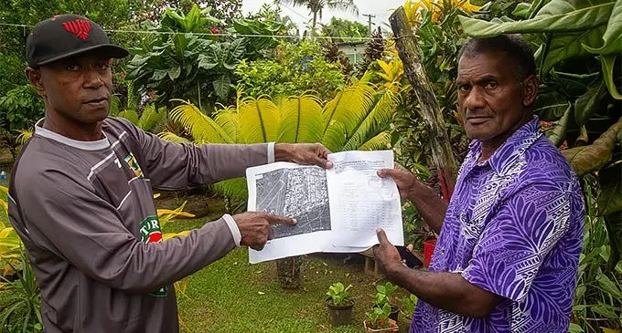 Koroi Tuibeqa (left), member of the Mataqali Matanikutu - Tokatoka Vusoi, with Josefa Veikara pointing to the reserve land said to be within the boundary of the mataqali land. Photo: Leon Lord