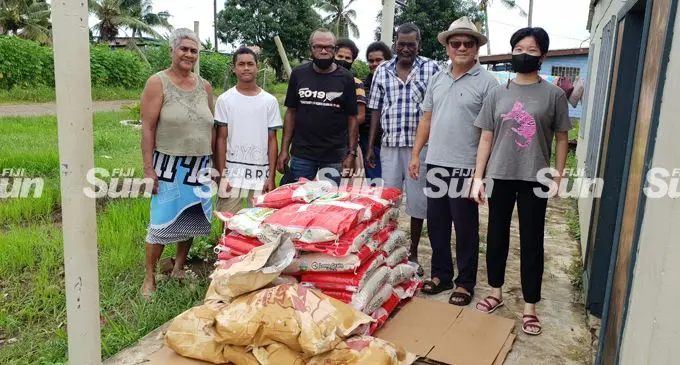 Food With Love Mission Fiji group president, Paul Kim (second from right) with his team and residents of California Road in Lautoka on February 10, 2022. Photo: Nicolette Chambers