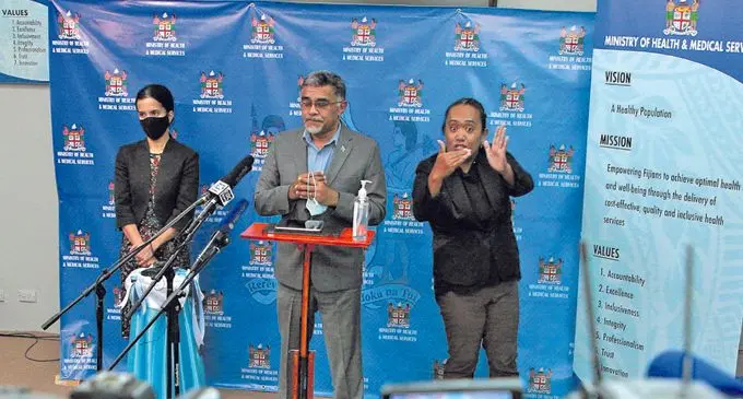From left: Ministry of Health and Medical Services head of Protection Services Dr Aalisha Sahukhan, Health and Medical Services Permanent Secretary Dr James Fong and sign language interpreter Claudette Wilson on April 29, 2021. Photo: Leon Lord