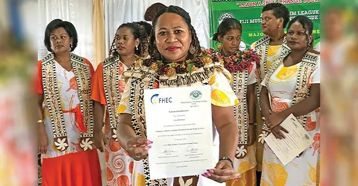 Luisa Qiolevu with her certificate in Fashion, Manufacturing and Design after graduat- ing from the Makoi Women Vocational Centre.