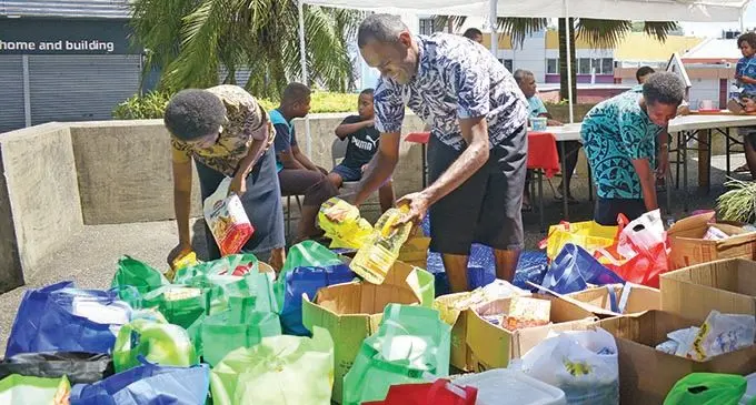 Members of The Methodist Church Suva circuit, (from left) Selai Tuinisau, Motisela Gonevou and Tavisi Tawake during their food drive at Centenary Church on December 19, 2020.  Photo: Ronald Kumar