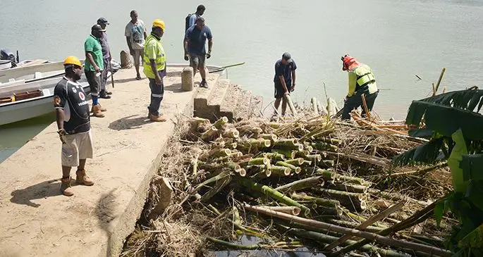 Ministry of Forestry staff together with officers from the Police Special Response Unit clean the debris left by Tropical Cyclone Harold at Beqa Jetty in Navua Town in April 15, 2020. Photo: Ronald Kumar