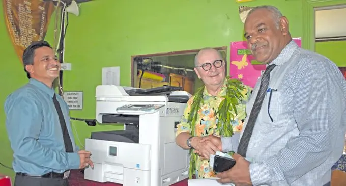 (Left-Right) Qumusea District School head teacher Mohammed Khan with Nukubati Island Resort Owner Peter  Bourke and Divisional Education Officer Northern Selemo Drokamaisau trying out the three in one Printer, scanner and photocopier using the Solar in Macuata February 7, 2018. Photo: WATI TALEBULA