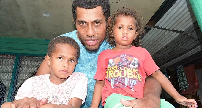 Reunited... 5 year-old Sainimili Ravavou and 3 year-old Kinisimere Seru with their father, Sailasa Takali 35 back at their Caubati home after they went missing from home on February 5, 2020. Photo: Ronald Kumar.