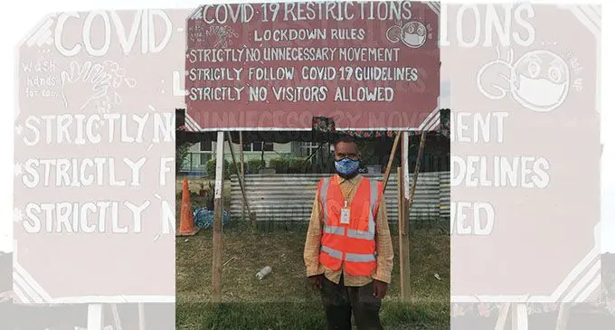 Vunitogoloa Village headman Joseva Manikiwai next to the village COVID-19 notice board. Photo: Kelera Sovasiga