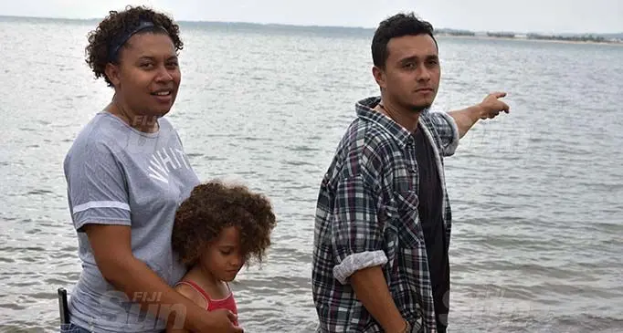 From, left: Laisani Delana with her daughter, Clara Fisher and Tristan Smith pointing to the spot where they witnessed the shark. Photo: Mereleki Nai