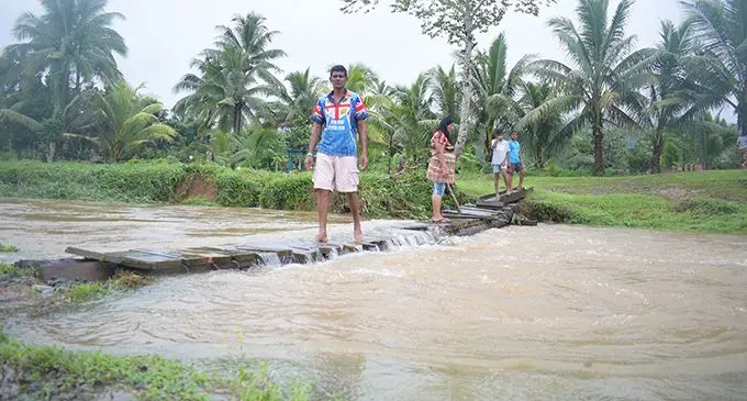 Wainadoi resident Gurdeep Singh makes his way to the main road after flood water on February 7, 2019. Photo: Ronald Kumar 