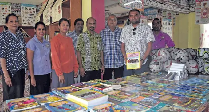 USA businessman Sajal Narayan (second from right) hands over the package at the school yesterday. Photo: WAISEA NASOKIA