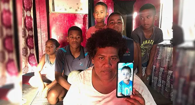 Paulini Ralia, 43, holds the picture of her late grandson, Benjamin Ralia, as Benjamin’s cousins, Esther Biu, William Nasilasila, Apisalome Kunavere, Josua Cagilaba, Ratu Lame Noki look on at their residence in Qeleloa, Nadi. Photo: Waisea Nasokia