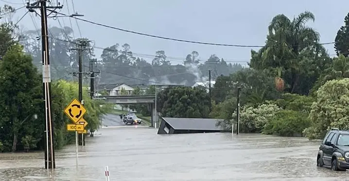 Candia Road in Auckland, New Zealand under water yesterday from heavy rain. Photo: RNZ Pacific