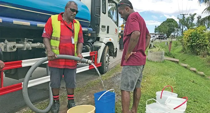A Tamavua villager filling buckets with water from the water carting trucks. Photo: Neelam Prasad.