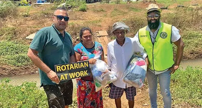 Navinesh Singh (left) and Prashant Anurag (right) in Vanua Levu with a couple who they have helped as part of their relief aid for those affected by Cyclone Yasa. 