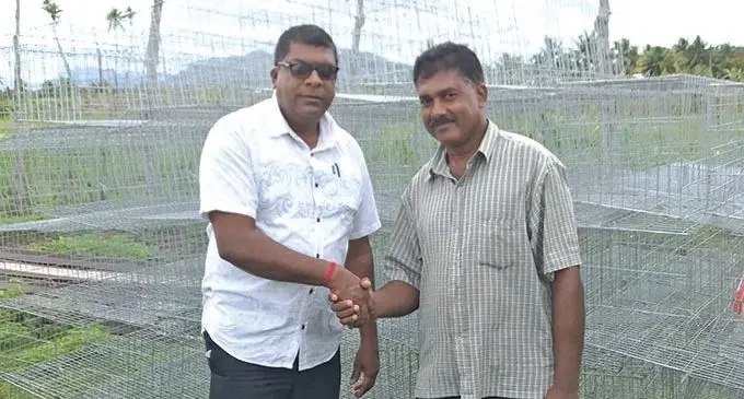 Minister for Agriculture Mahendra Reddy (left) with Basha Poultry Owner Sheik Adam Basha during the handing over of layer cages in tuatua, Labasa on November 28, 2020. Photo: Shratika Naidu  