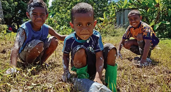 From left: Kinijoji Seru, 9, Rusiate Jitoko, 6 with Samisoni Raisua, 9, during the Saru Village clean up campaign in Lautoka on April 5, 2021. Photo: Nicolette Chambers