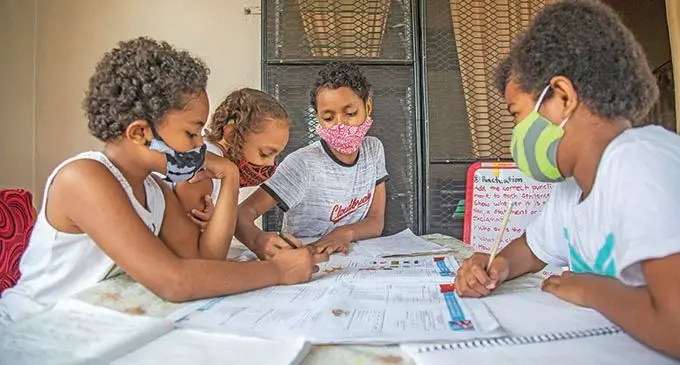 Theresa Ledua, 9, Kristelle Tuitoga, 9, Shanique Tuitoga, 10, and Sainiana Vesikula, 9, utilising the Ministry of Education literacy and numeracy lift out in the Fiji Sun at their home in Nadawa on June 30, 2021.  Photo: Leon Lord.