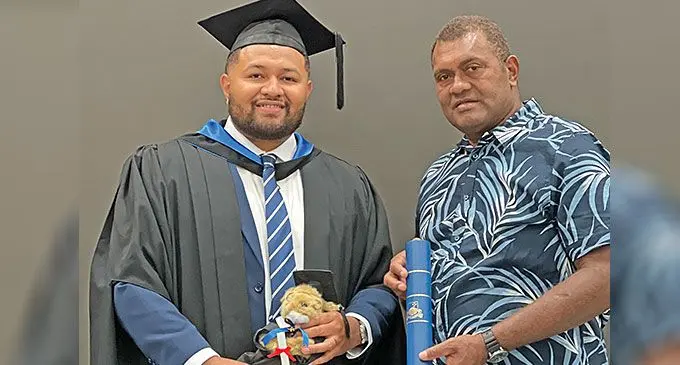 Australian National University’s Master in International Law and Diplomacy graduate Peniasi Kaloukocei Apisai with his father Kelevi Cavuduadua after his graduation in Australia on December 14, 2024.