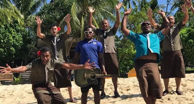 Tourism staff in Fiji greet visitors to their resort in the Yasawa Islands