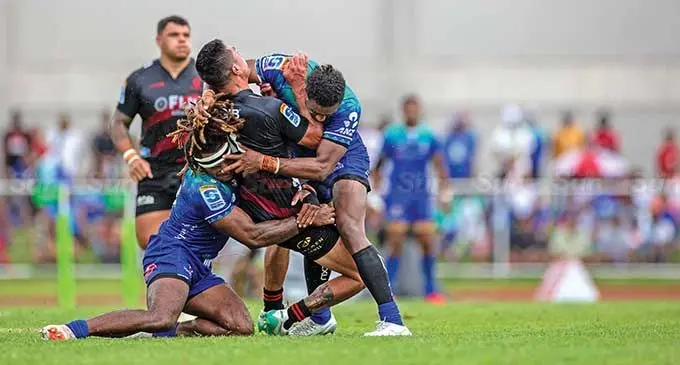 Swire Shipping Fijian Drua’s Selestino Ravutaumada and Iosefo Masi tackle a Crusaders player at Churchill Park, Lautoka, on March 9, 2024. Photo: Leon Lord