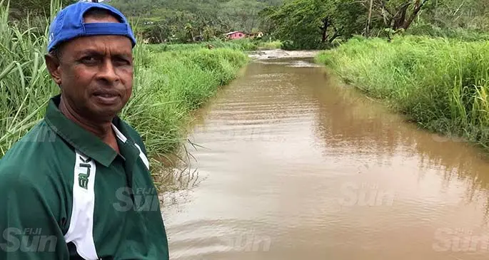 Ramesh Chandra couldn’t go home as the crossing behind him at Urata, Labasa was underwater on January 28, 2021. Photo: Shratika Naidu