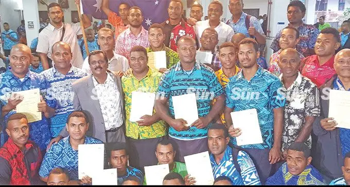 Minister for Employment, Productivity, Industrial Relations, Youth and Sports Praveen Bala (standing front third from left) with workers under the Pacific Labour Mobility scheme, at Kshatriya Hall, Suva. Photo: Viliame Tawanakoro