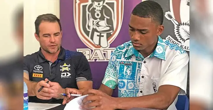 Lemeki Radovu (right) signs his North Queensland Cowboys academy contract at the Fiji National Rugby League headquarters in Suva on September 6, 2023. On the left is Cowboys recruitment manager Dane Campbell. Photo: Sereana Salalo
