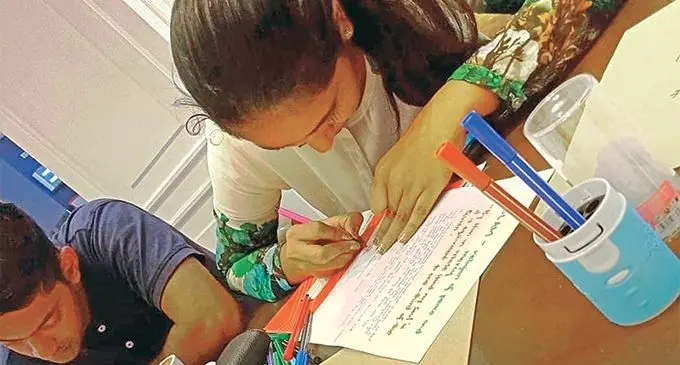 Two individuals writing a heartfelt letter for the 50 victims who died in a terrorist attack at two mosques in Christchurch, New Zealand last week. 