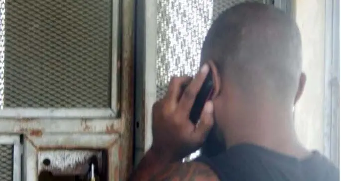 Detainees using ICRC donated mobile phone Photo: CSSI