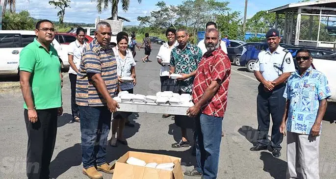 Lautoka Cane Producers Association president Tazim Ali Khan in red shirt (third from right) hands over food to the Nadi hospital medical team on Friday May 1, 2020. Photo: Waisea Nasokia