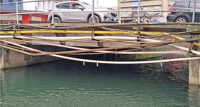These pipes dangling off the Thomson St bridge in Suva pose a risk to boat owners who use the creek. Photo: Satish Nakched