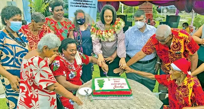 Minister for Women, Children and Poverty Alleviation Rosy Akbar cuts the celebration cake with residents and staff of the Suva Golden Age Home in Samabula on December 20, 2021. Photo: Inoke Rabonu