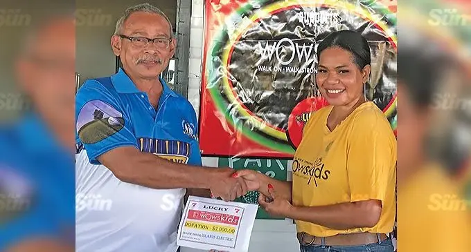 Community worker Allen Lockington, hands over the cheque to staff nurse Laisa Raisamu. Photo: Waisea Nasokia