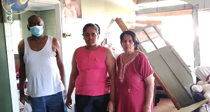 Madhwan Goundar (left) with his granddaughter, Nidhi Goundar (middle) and wife, Him Devi (right) inside their damaged home at Field 40, Lautoka on July 9, 2021. Photo: Nicolette Chambers