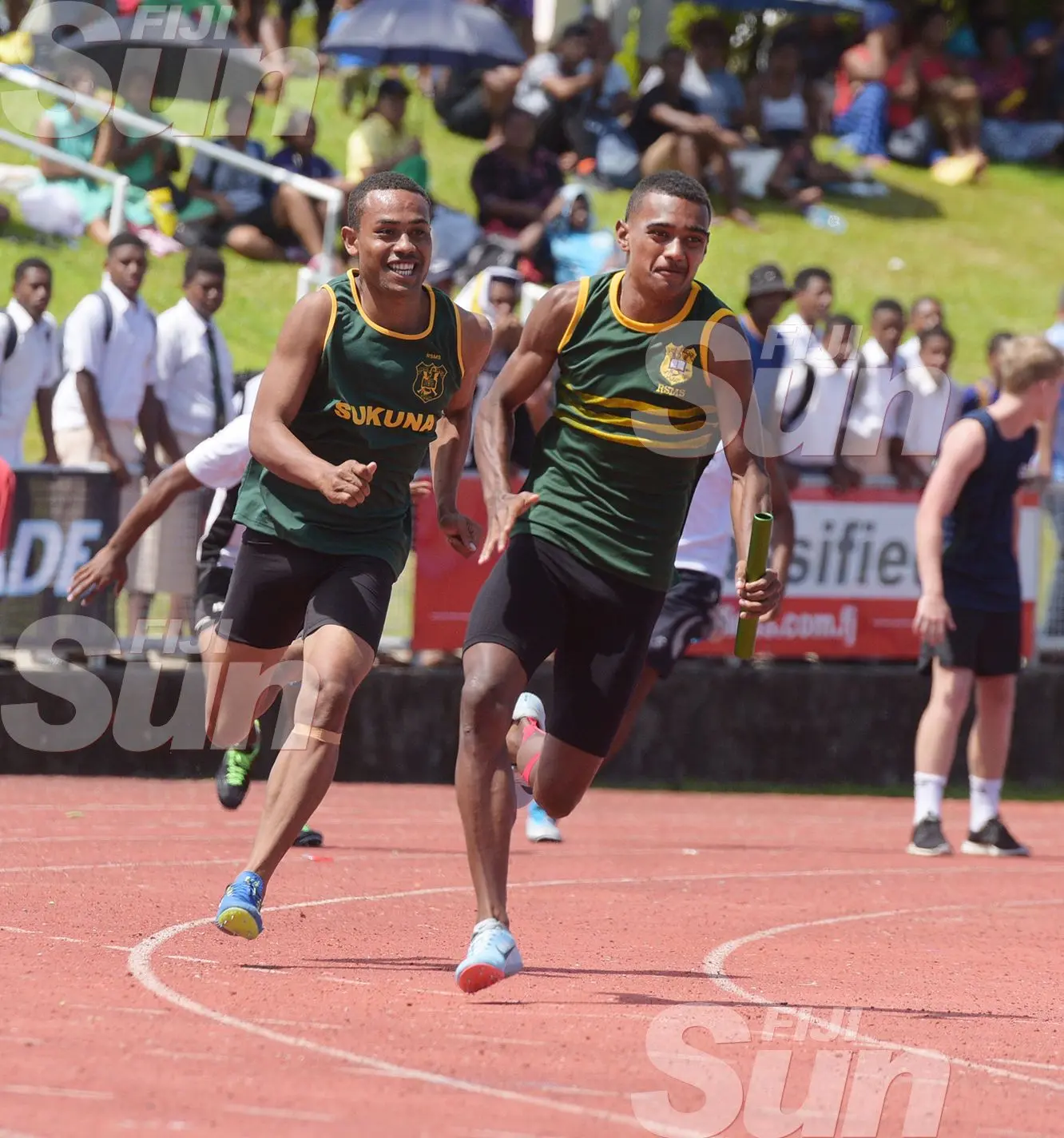 RSMS final runner, Saula Caucakacaka gets the baton from Seru Naibuka inter-boys 4x1 relay action at ANZ Stadium . Photo: Ronald Kumar.