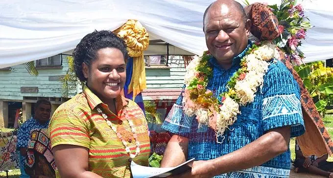Laiseana Rokocoko (left) receiving her certificate from the Minister of Forestry, Osea Naiqamu during the Fiji National University Sustainable Livelihood Training Programme graduation at Yavusania Village in Nadi. Photo: Mereleki Nai