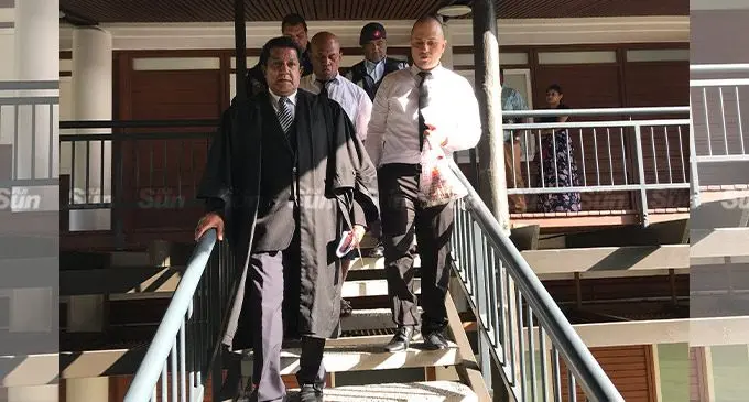 Australian national Joseph Abourizk (right) and former Fijian taxi driver Josese Muriwaqa (middle back) with their lawyer Abhay Singh outside the Supreme Court of Fiji on August 25, 2022. Photo: Ashna Kumar