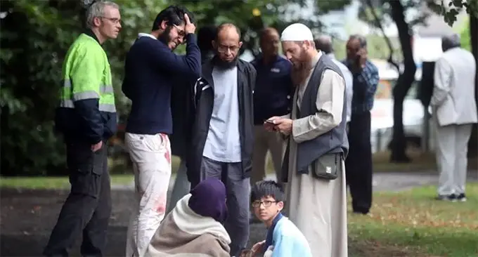 Stunned and bloodied workshippers outside one of the Christchurch mosques.CREDIT:JOHN KIRK-ANDERSON/STUFF.