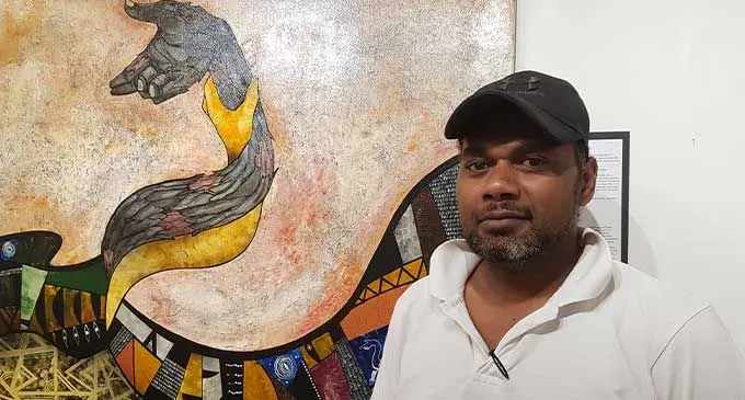 Irami Buli standing next to his canvas titled “Vueta” at the Oceania Gallery in USP, Suva. Photo: Viliame Tawanakoro