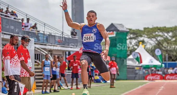 Waisele Inoke of Mahatma Ghandi Memorial School leaps into the air during his long jump event at the HFC Bank Stadium, Suva on August 19, 2022. He won gold in the long jump and senior boys 100 metres event. Photo: Leon Lord