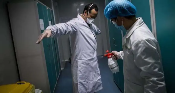 Medical staff conduct disinfection after work in Wuhan, central China's Hubei Province, Feb. 24, 2020. (Xinhua/Xiao Yijiu)