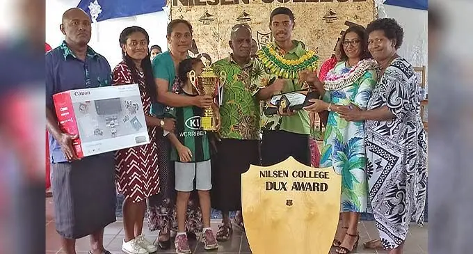 Sunia William Naraikaba with his family holding the awards during the Nilsen College prize giving day last week. Photo: Waisea Nasokia