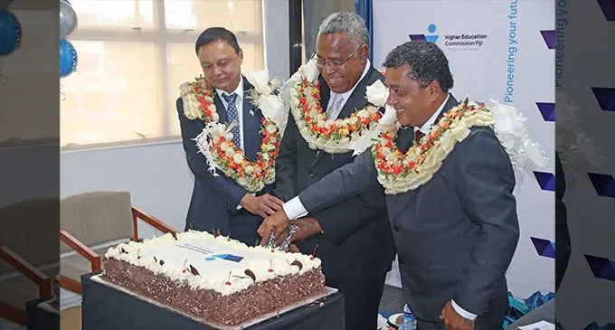 Higher Education Commission Director Rohit Kishore, Assistant Minister for Education Iliesa Vanawalu and Commission Chair Steve Chand cut the celebration cake on July 19, 2023. Left: The new logo. Photo: Inoke Rabonu